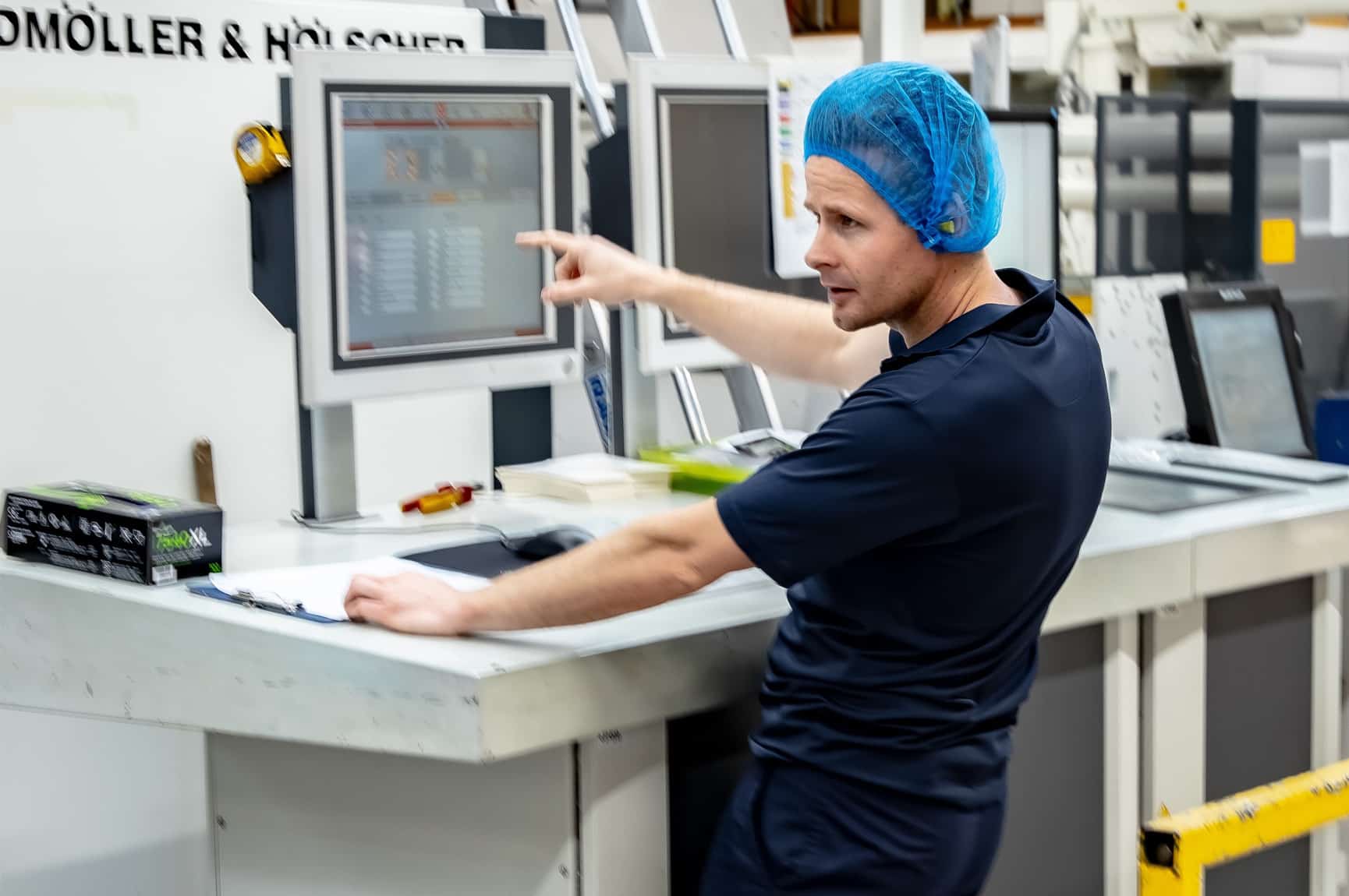 Factory worker operating machinery