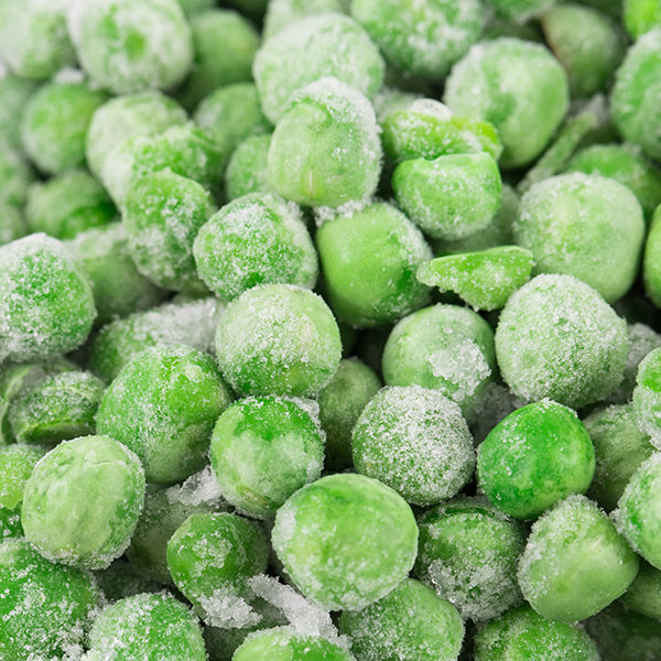 Green Frozen peas as background in closeup