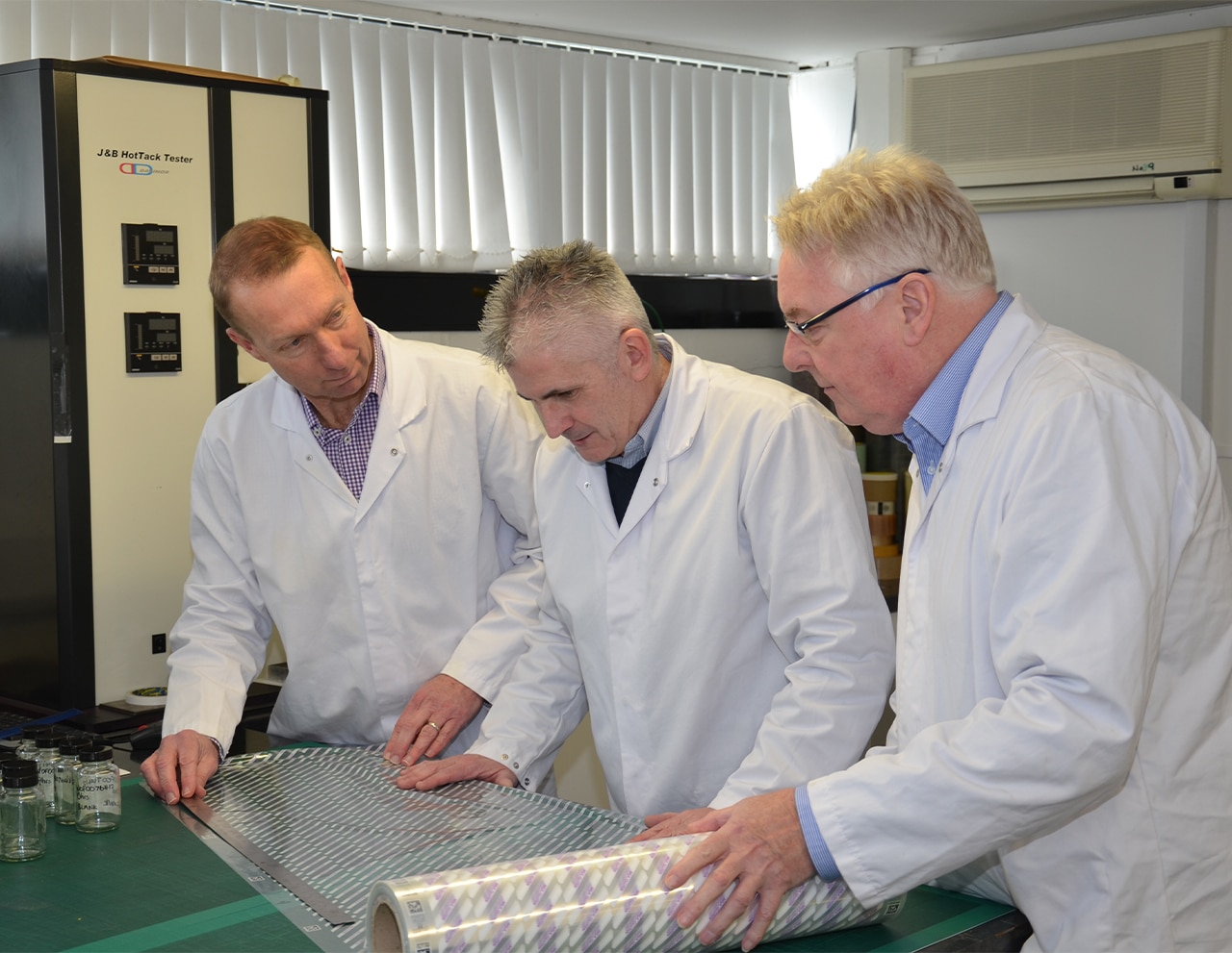 Three experts testing out some packaging film
