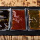 Different,Sauces,In,Vacuum,Sealed,Plastic,Packaging,On,Black,Slate
