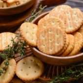 Bowl,With,Crackers,On,Wooden,Background